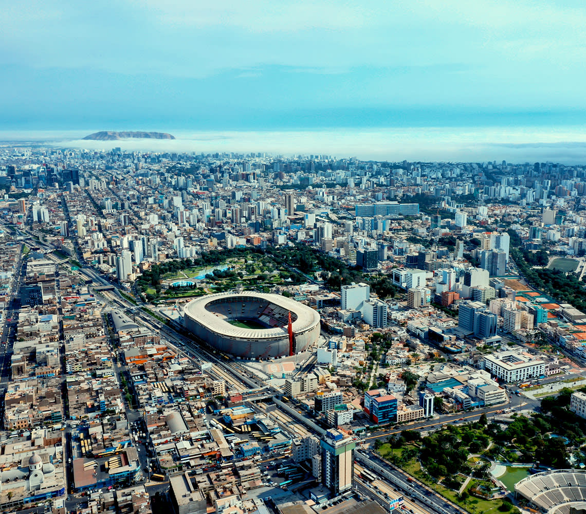 Bird's-eye view of cityscape, illustrating the city's infrastructure and natural surroundings in a dynamic urban environment.